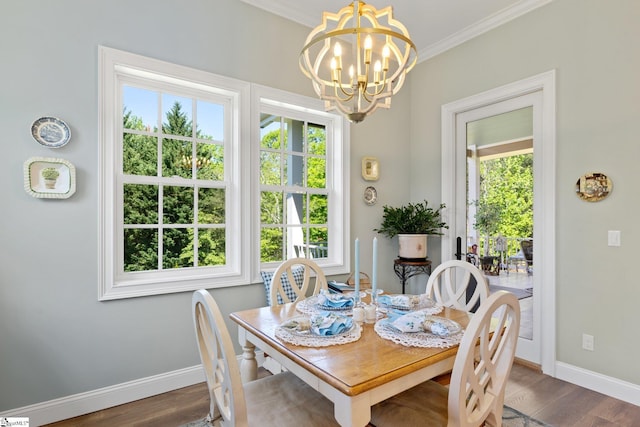 dining room featuring dark wood finished floors, baseboards, ornamental molding, and a healthy amount of sunlight