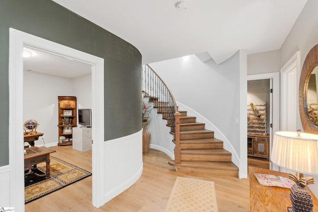 entrance foyer with light wood-style flooring and stairway