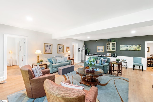 living area featuring recessed lighting, light wood-style flooring, and baseboards