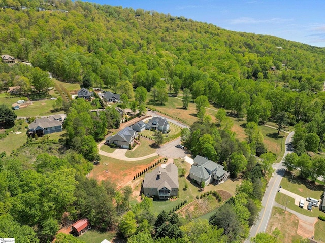 drone / aerial view with a forest view and a residential view