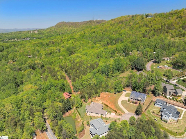 birds eye view of property with a view of trees