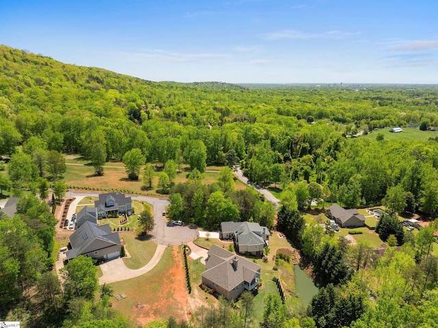 drone / aerial view featuring a view of trees