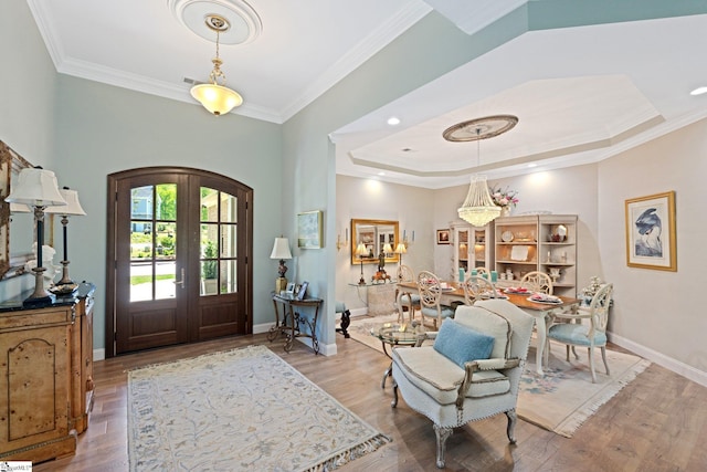 entrance foyer featuring ornamental molding, wood finished floors, and a tray ceiling