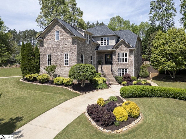craftsman house featuring stone siding, a front lawn, and a shingled roof