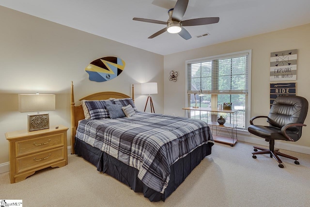 bedroom featuring baseboards, visible vents, light colored carpet, and ceiling fan
