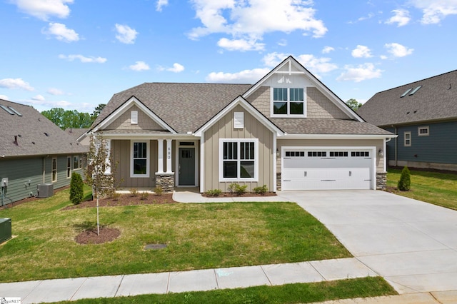craftsman house with board and batten siding, driveway, a front yard, and central air condition unit