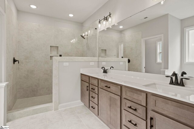 full bathroom featuring walk in shower, visible vents, a sink, and double vanity
