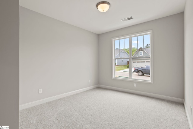 carpeted empty room with baseboards and visible vents