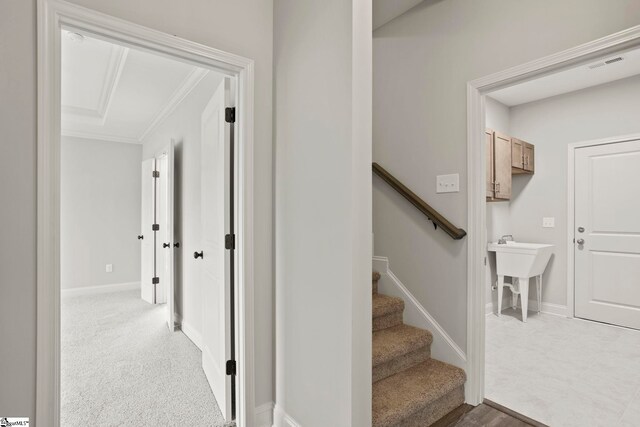 hall featuring baseboards, crown molding, and visible vents