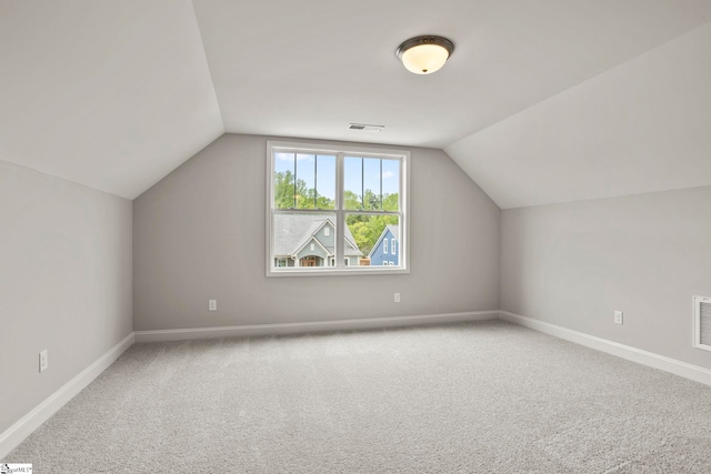 bonus room featuring lofted ceiling, baseboards, visible vents, and carpet
