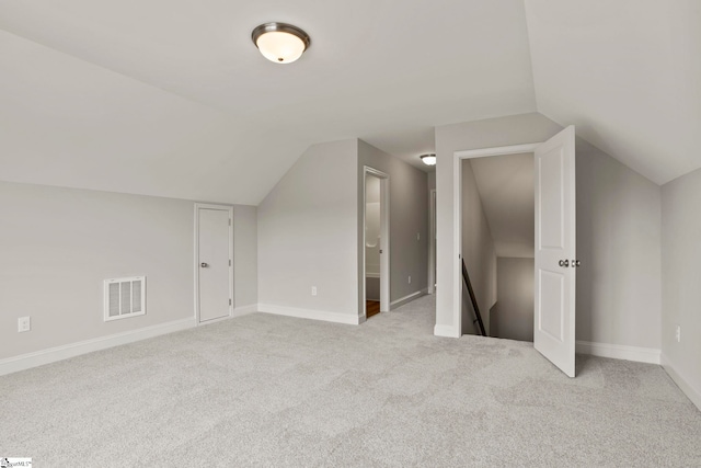 bonus room featuring lofted ceiling, baseboards, visible vents, and carpet