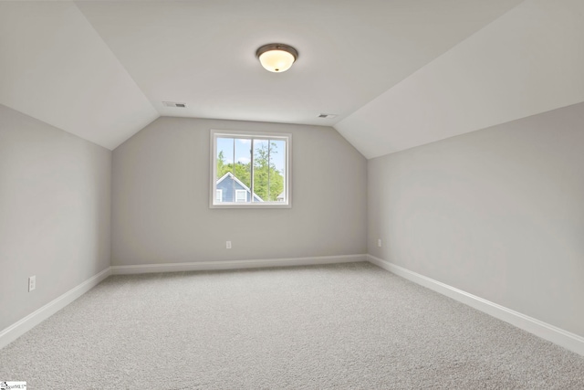bonus room featuring baseboards, lofted ceiling, visible vents, and carpet floors