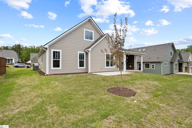 back of property featuring a patio area and a yard