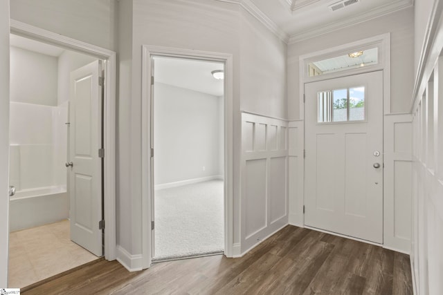 foyer with ornamental molding, dark wood-type flooring, and visible vents
