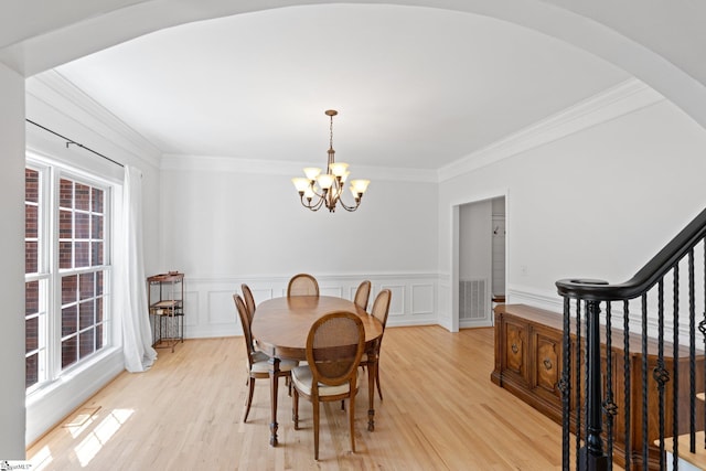 361 E Killarney Lk, Moore, SC 29369 - dining space with arched walkways, light wood-type flooring, visible vents, a notable chandelier, and crown molding