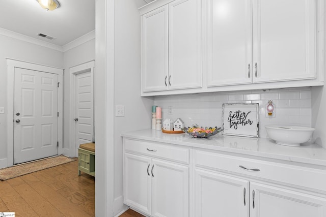 309 Nebbiolo Ln, Simpsonville, SC 29681 - bar area featuring ornamental molding, tasteful backsplash, and light wood-style floors