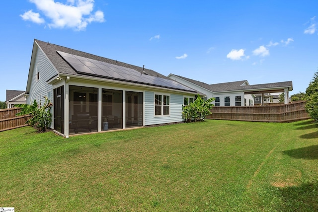 309 Nebbiolo Ln, Simpsonville, SC 29681 - back of house featuring roof mounted solar panels, a sunroom, and a shingled roof