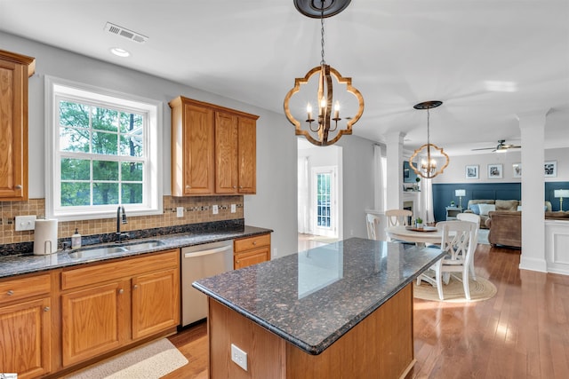 kitchen with dishwasher, visible vents, a sink, and tasteful backsplash
