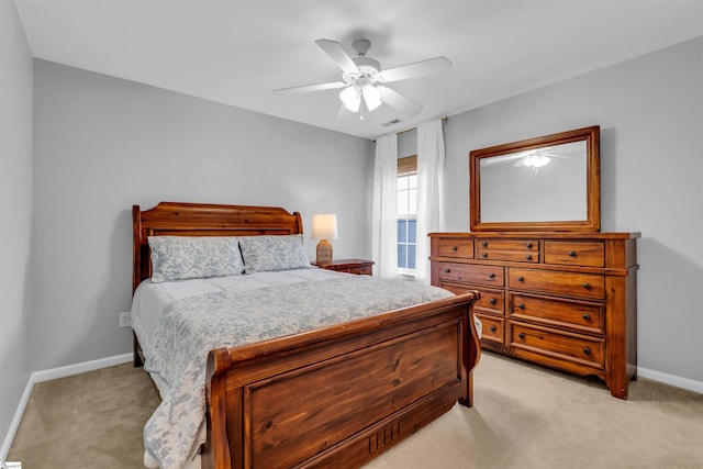 bedroom featuring visible vents, a ceiling fan, baseboards, and light carpet