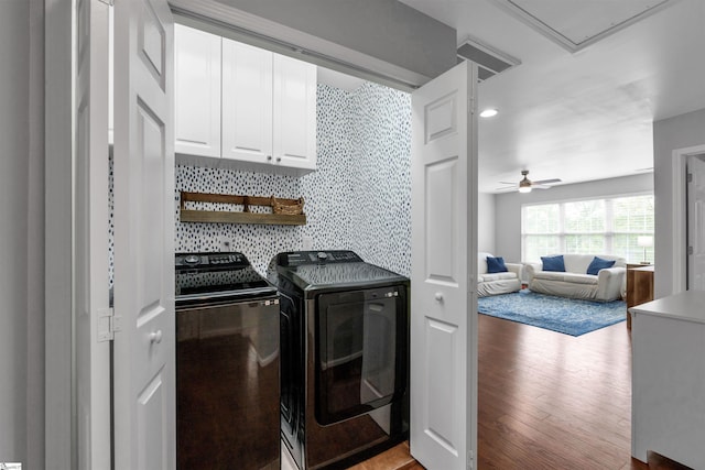 laundry area featuring attic access, ceiling fan, cabinet space, light wood finished floors, and washing machine and dryer