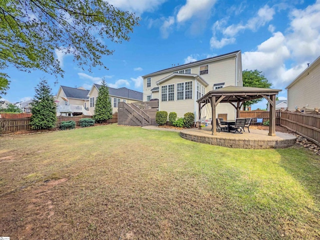 back of house featuring a fenced backyard, a gazebo, stairway, a yard, and a patio