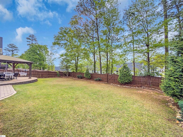 view of yard featuring a fenced backyard, a gazebo, and a patio area
