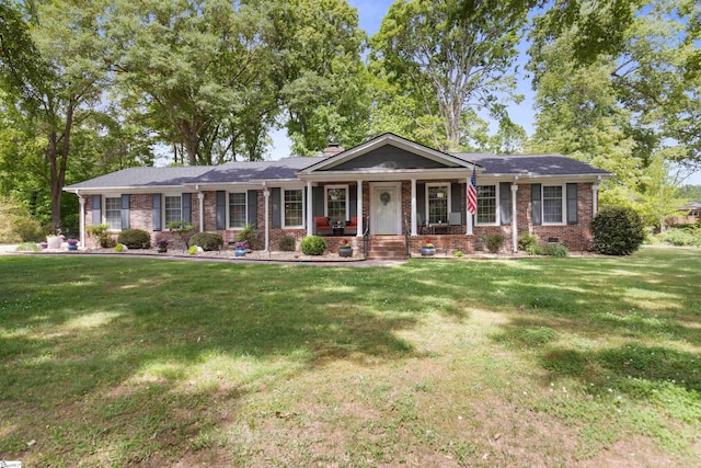 ranch-style house with brick siding, a porch, and a front yard