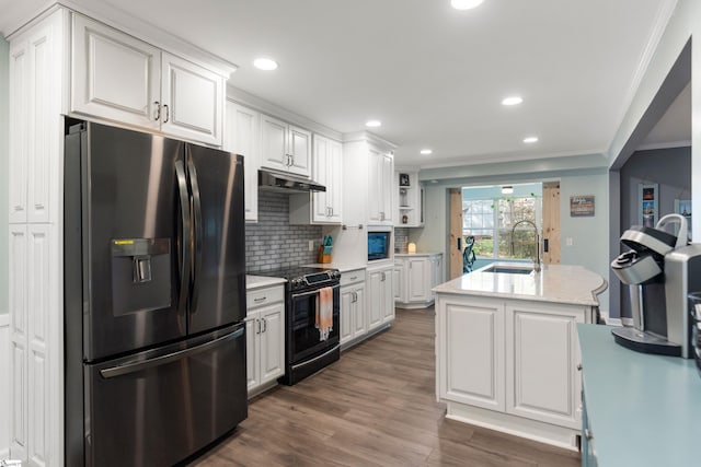 kitchen with white cabinets, electric range, stainless steel fridge with ice dispenser, under cabinet range hood, and ornamental molding
