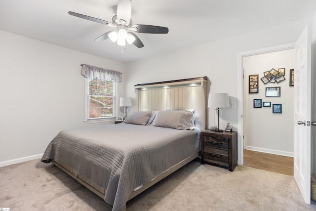 carpeted bedroom with a ceiling fan and baseboards