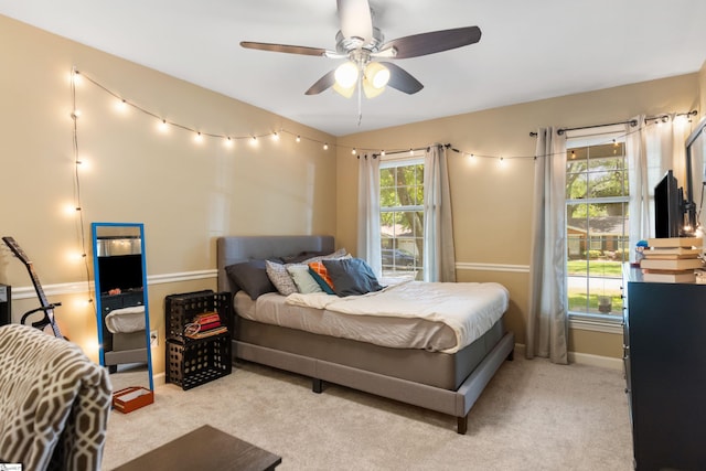 carpeted bedroom featuring a ceiling fan and baseboards