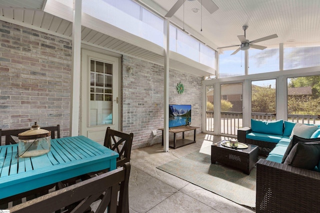 sunroom / solarium featuring an outdoor living space, a ceiling fan, and plenty of natural light