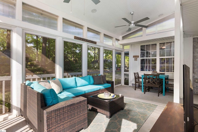 sunroom with an outdoor living space, outdoor dining space, and ceiling fan