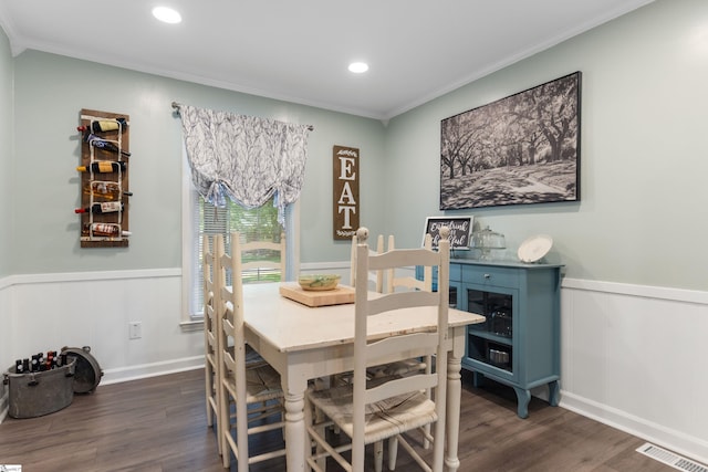 dining room with recessed lighting, a wainscoted wall, visible vents, ornamental molding, and dark wood-type flooring