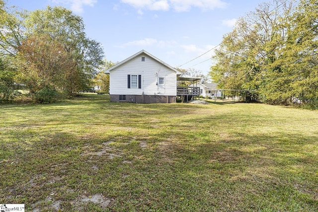 exterior space with a wooden deck and a yard