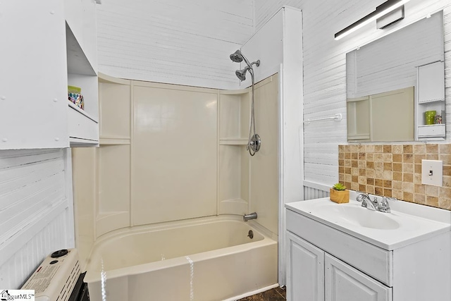 full bathroom with washtub / shower combination, vanity, and decorative backsplash