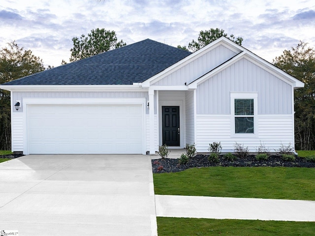 225 Maxwell Dr, Easley, SC 29642 - view of front of home with roof with shingles, concrete driveway, board and batten siding, a front yard, and a garage