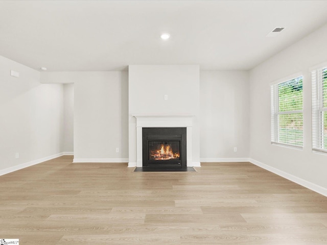 225 Maxwell Dr, Easley, SC 29642 - unfurnished living room featuring a fireplace with flush hearth, light wood finished floors, recessed lighting, and baseboards