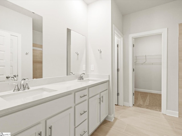 225 Maxwell Dr, Easley, SC 29642 - bathroom with double vanity, a walk in closet, tiled shower, and baseboards