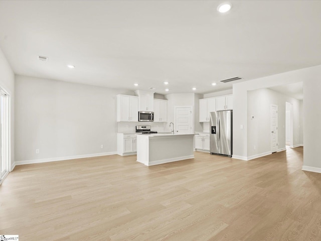 225 Maxwell Dr, Easley, SC 29642 - unfurnished living room with light wood finished floors, recessed lighting, baseboards, and a sink