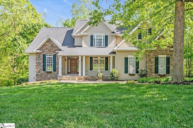 221 Byars St, Greer, SC 29651 - craftsman-style home with stone siding, covered porch, a shingled roof, and a front yard
