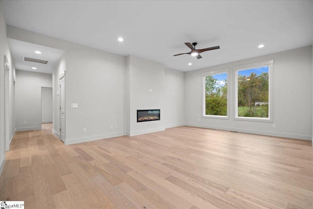 204 Tot Howell Rd, Greer, SC 29651 - unfurnished living room featuring light wood finished floors, a glass covered fireplace, recessed lighting, visible vents, and ceiling fan