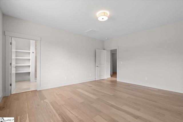 204 Tot Howell Rd, Greer, SC 29651 - unfurnished bedroom featuring baseboards, a spacious closet, and light wood-style floors