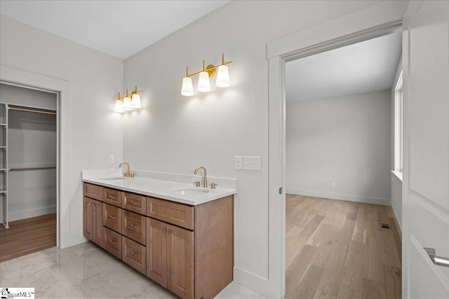 204 Tot Howell Rd, Greer, SC 29651 - full bathroom featuring double vanity, wood finished floors, baseboards, and a sink