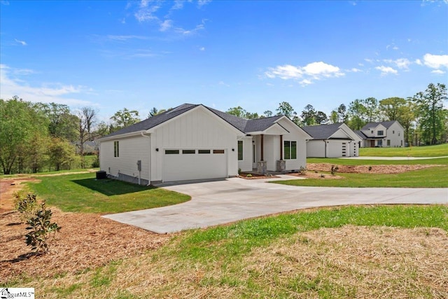 204 Tot Howell Rd, Greer, SC 29651 - view of front of house featuring an attached garage, driveway, board and batten siding, and a front lawn