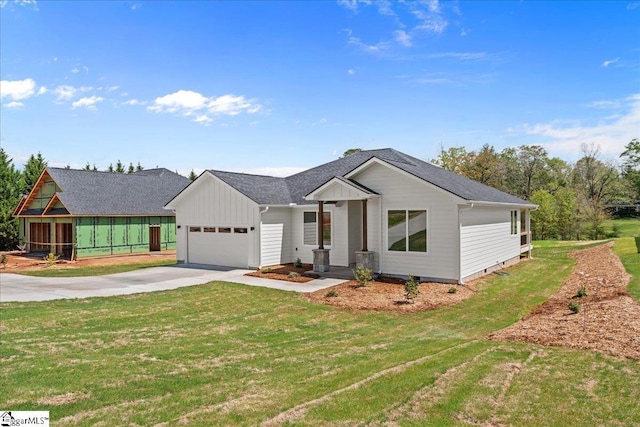 204 Tot Howell Rd, Greer, SC 29651 - view of front facade with concrete driveway, a front lawn, board and batten siding, a shingled roof, and a garage
