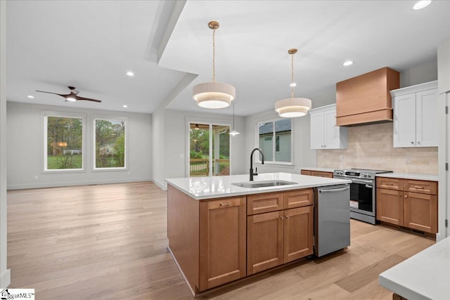 204 Tot Howell Rd, Greer, SC 29651 - kitchen with an island with sink, stainless steel appliances, light countertops, a sink, and premium range hood
