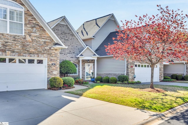 view of front facade featuring driveway and stone siding