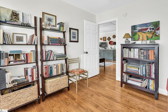 sitting room with wood finished floors and baseboards