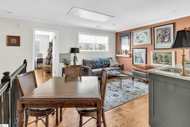 dining room featuring attic access, recessed lighting, light wood-style floors, and ornamental molding