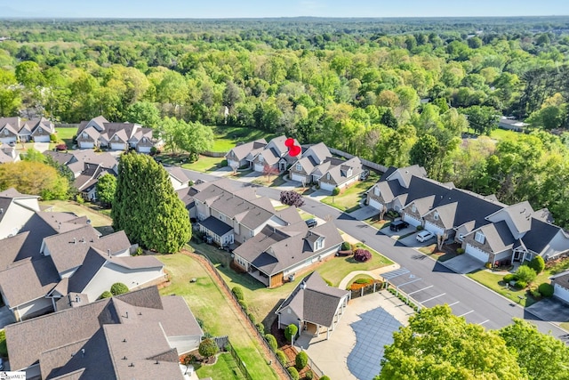 birds eye view of property with a residential view and a view of trees